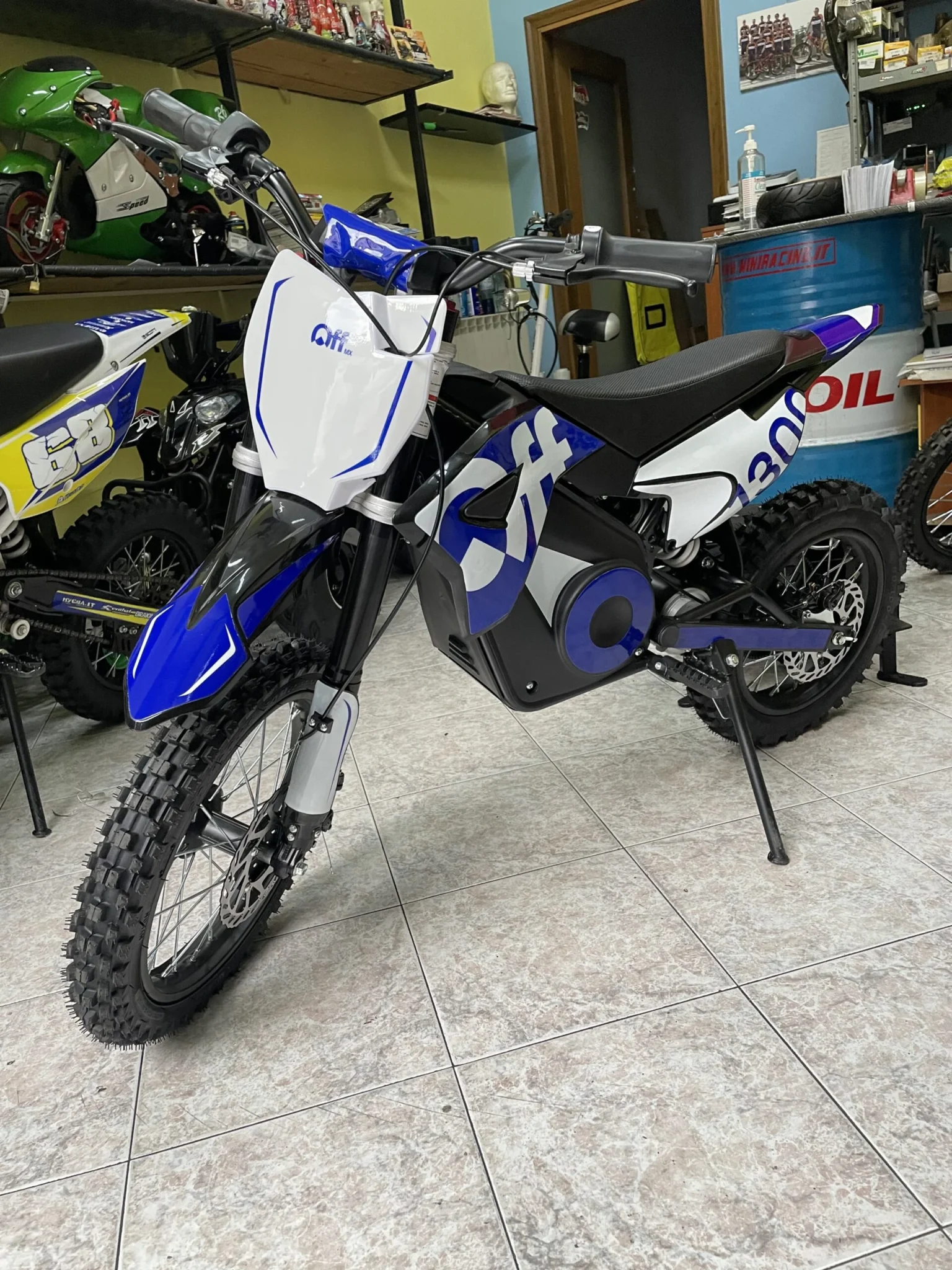 Pit bike elettrica OFFMX 1300W litio ruote 14″12″, foto 5